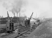 Whirleys unloading ore, Penna. R.R. [Pennsylvania Railroad] docks, Erie, Pa., ca 1900. Creator: William H. Jackson