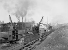 Whirleys unloading ore, Penna. R.R. [Pennsylvania Railroad] docks, Erie, Pa., ca 1900. Creator: William H. Jackson