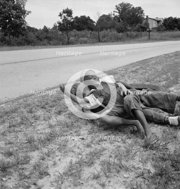 White and Negro boy wrestling by side of road, Person County, North Carolina, 1939. Creator: Dorothea Lange.