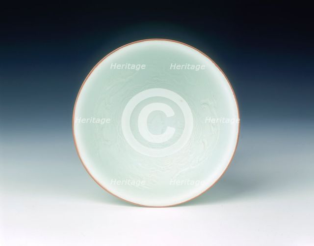 White glazed bowl with moulded design of dragons and carp, Qing dynasty, China, 1650-1670. Artist: Unknown