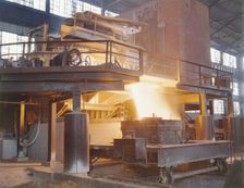 White-hot steel pours like water from a 35-ton electric furnace, Allegheny Ludlum Steele..., (1941?) Creator: Alfred T Palmer