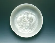 White jade bracketed saucer with two catfish and fungus in relief, Qing dynasty, mid 18th century. Creator: Unknown