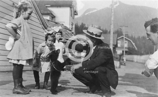 White people with bear cub, between c1900 and c1930. Creator: Unknown.