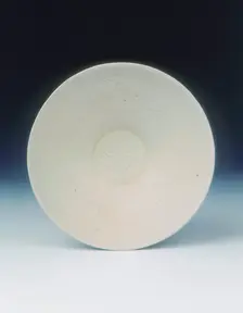 White ware bowl with moulded twin fish and floral pattern, Jin dynasty, China, 12th century. Creator: Unknown