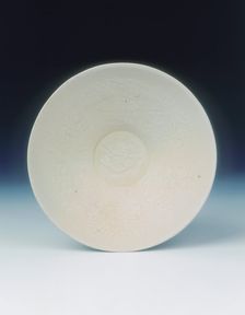 White ware bowl with moulded twin fish and floral pattern, Jin dynasty, China, 12th century. Creator: Unknown