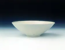 White ware bowl with moulded twin fish and floral pattern, Jin dynasty, China, 12th century. Creator: Unknown