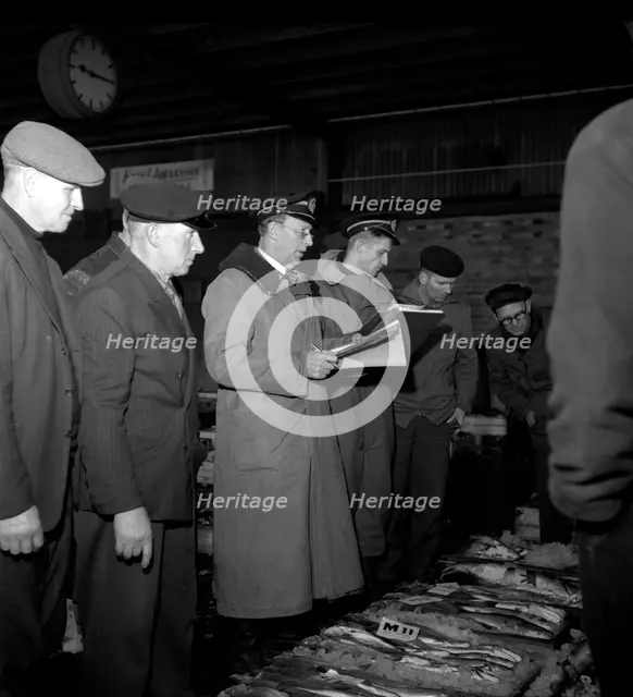 Wholesalers and fishmongers at the fish auction, Gothenburg, Sweden, 1960. Creator: Torkel Lindeberg.