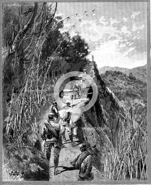 With the Lushai Expedition: coolies carrying bags of rice up a mountain path, 1890. Creator: R. Taylor.