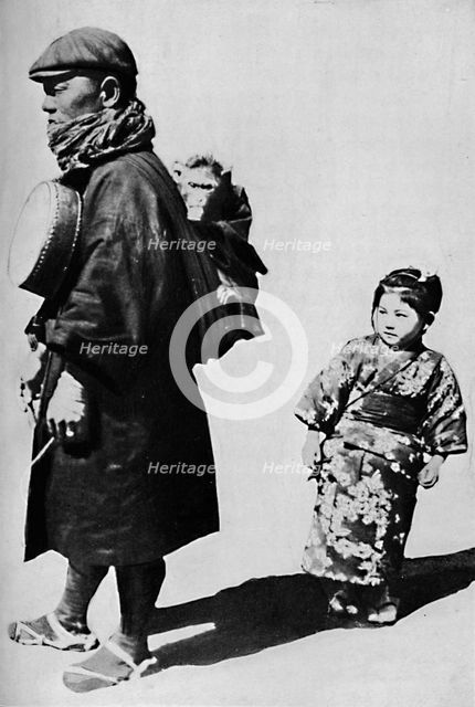 ''With his drum and monkey he is Japan's equivalent to our old-style organ grinder', c1900, (1921).  Artist: Julian Leonard Street.