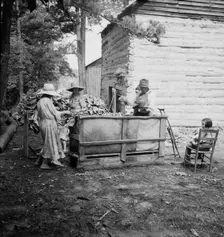 Wives of tobacco tenants pile the tobacco..., Granville County, North Carolina, 1939. Creator: Dorothea Lange