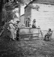 Wives of tobacco tenants pile the tobacco..., Granville County, North Carolina, 1939. Creator: Dorothea Lange