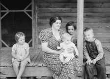 Wife and children of tobacco sharecropper on front porch, Person County, North Carolina, 1939. Creator: Dorothea Lange