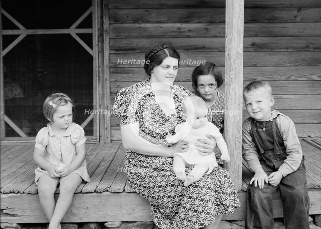 Wife and children of tobacco sharecropper on front porch, Person County, North Carolina, 1939. Creator: Dorothea Lange.
