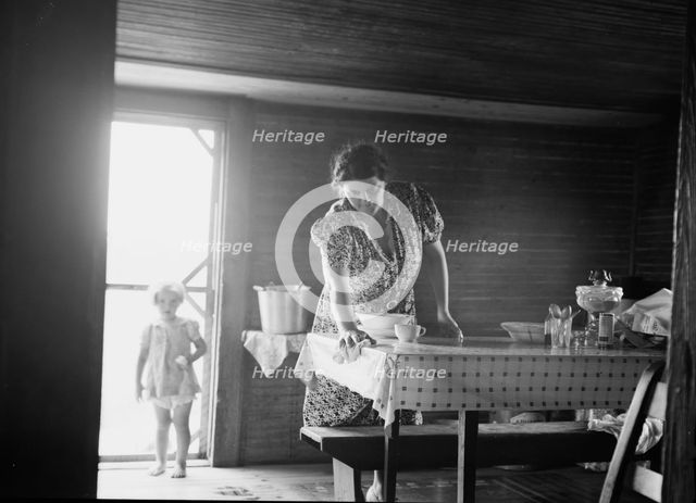 Wife of tobacco sharecropper in kitchen of home, Person County, North Carolina, 1939. Creator: Dorothea Lange.