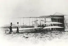 Wilbur and Orville Wright with Flyer II at Huffman Prairie, Dayton, Ohio, USA, May 1, 1904. Creator: NASA