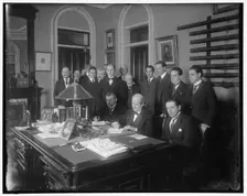 William Jennings Bryan with group at desk, between 1910 and 1920. Creator: Harris & Ewing