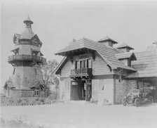 Windmill-shaped clock tower at left, and part of garage of Edmund..., Greenwich, Connecticut, 1908. Creator: Frances Benjamin Johnston