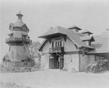 Windmill-shaped clock tower at left, and part of garage of Edmund..., Greenwich, Connecticut, 1908. Creator: Frances Benjamin Johnston