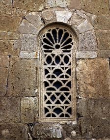 Window in the apse with a Visigothic lattice, in the church of San Juan de Baños