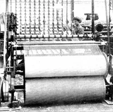 Winding the yarn off the bobbins on to warper's beams, 1909. Creator: Unknown