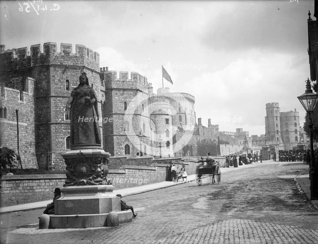 Windsor Castle from Pedscoe Street with a statue of Queen Victoria, Windsor, Berkshire, c1860-c1922. Artist: Henry Taunt