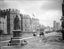 Windsor Castle from Pedscoe Street with a statue of Queen Victoria, Windsor, Berkshire, c1860-c1922. Artist: Henry Taunt