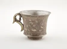 Wine cup with ring handle, birds, animals, and grape vines, Early Tang dynasty, late 7th century. Creator: Unknown