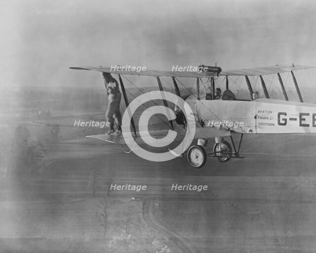 Wing walking without a harness on an Avro 504 biplane, 1932. Creator: Aerofilms.
