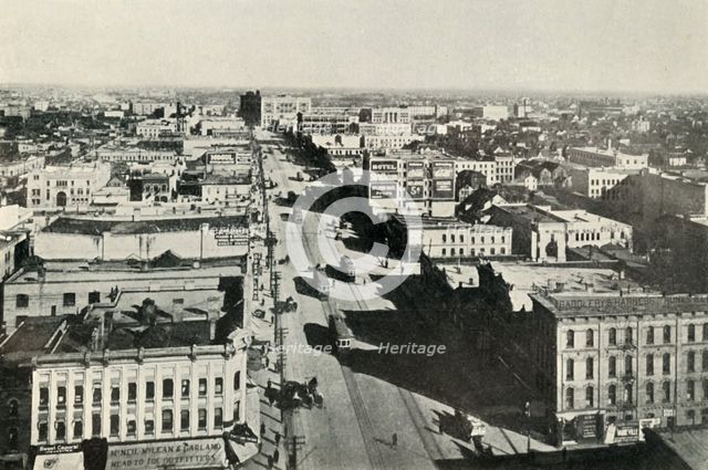 'Winnipeg To-Day; Looking Up Main Street. - The Rapid Growth of Modern Canada', c1930. Creator: Valentine & Sons Ltd.