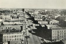 Winnipeg To-Day; Looking Up Main Street. - The Rapid Growth of Modern Canada c1930. Creator: Valentine & Sons Ltd