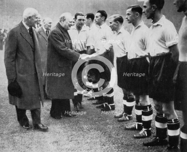 Winston Churchill greets the England football team, Wembley, London, October 1941.Artist: London News Agency
