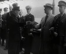 Winston Churchill Handing Franklin D. Roosevelt a Piece of Paper, 1941. Creator: British Pathe Ltd