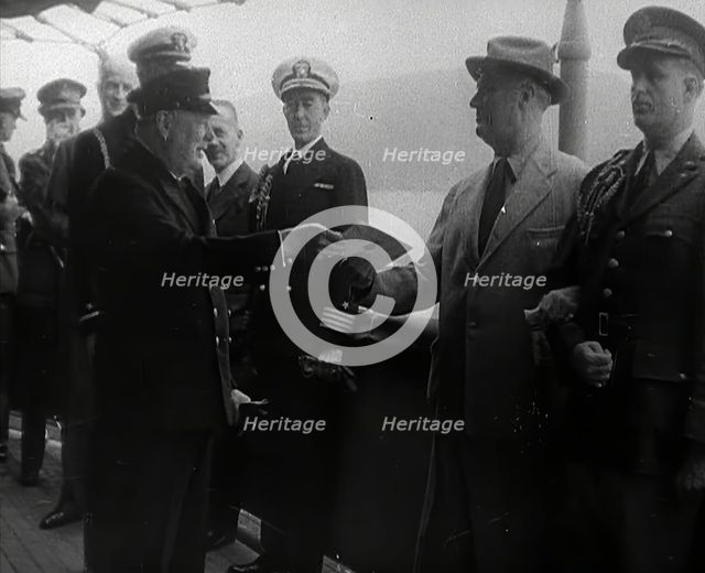 Winston Churchill Handing Franklin D. Roosevelt a Piece of Paper, 1941. Creator: British Pathe Ltd.