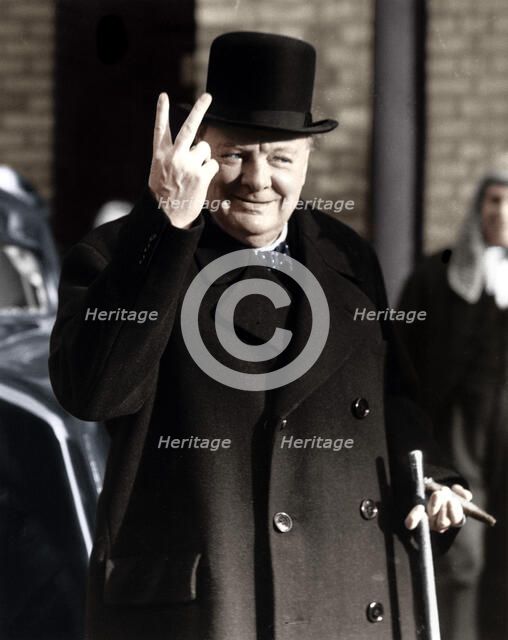 Winston Churchill making his famous V for Victory sign, 1942. Artist: Unknown