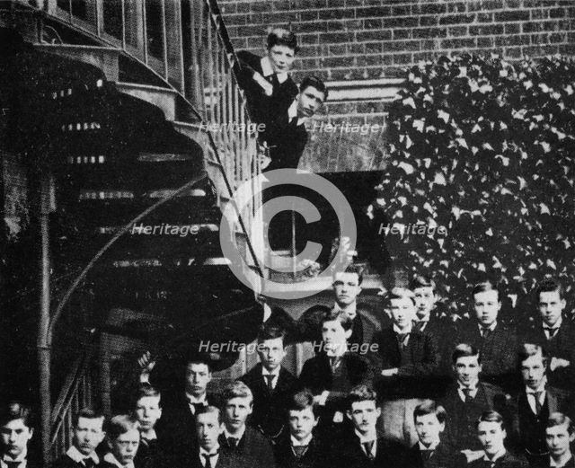 'Winston climbing a staircase, while the class pose', c1889, (1945). Artist: Unknown.