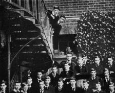 Winston climbing a staircase, while the class pose c1889, (1945)