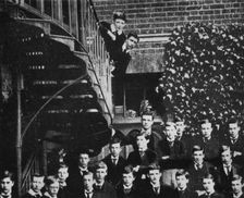 Winston climbing a staircase, while the class pose c1889, (1945)