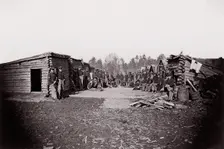 [Winter Quarters, troops with row of cabins]. Brady album, p. 128, 1861-65. Creator: Unknown