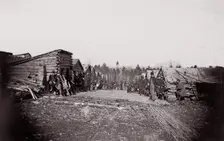 [Winter Quarters, troops with row of cabins]. Brady album, p. 128, 1861-65. Creator: Unknown