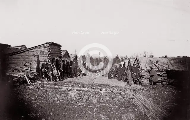 [Winter Quarters, troops with row of cabins]. Brady album, p. 128, 1861-65. Creator: Unknown.