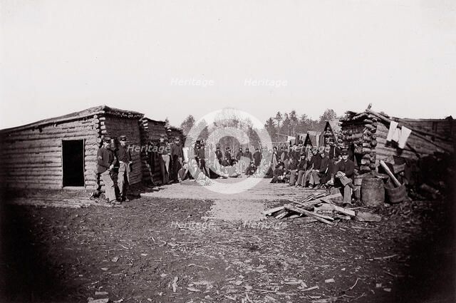 [Winter Quarters, troops with row of cabins]. Brady album, p. 128, 1861-65. Creator: Unknown.