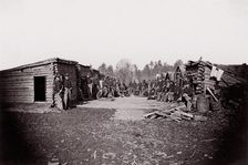 [Winter Quarters, troops with row of cabins]. Brady album, p. 128, 1861-65. Creator: Unknown