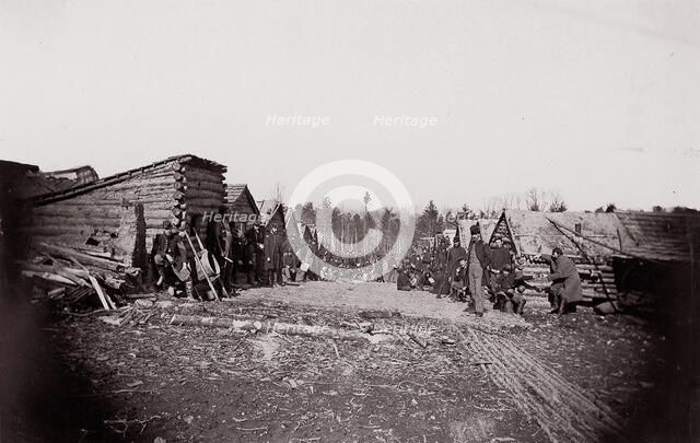 [Winter Quarters, troops with row of cabins]. Brady album, p. 128, 1861-65. Creator: Unknown.