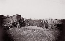 [Winter Quarters, troops with row of cabins]. Brady album, p. 128, 1861-65. Creator: Unknown