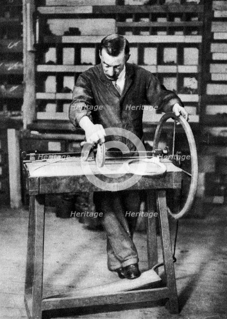 Wire being wound into springs for spring-locks, London, 1926-1927. Artist: Unknown