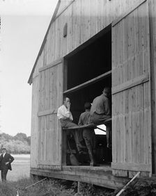 Wright Flights, Fort Myer, Va, July 1909 - Hangar, Wilbur Wright, Right, Showing His Objection To... Creator: Harris & Ewing