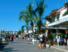 Tourists checking out a restaurant menu, Puerto de Mogan, Gran Canaria, Canary Islands. Creator: Peter Thompson