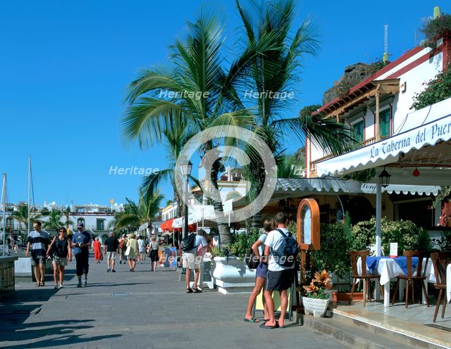 Tourists checking out a restaurant menu, Puerto de Mogan, Gran Canaria, Canary Islands. Creator: Peter Thompson.