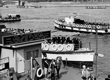 Tourists on a river cruise, Tower Pier, Tower Hamlets, London, c1960s. Creator: Unknown