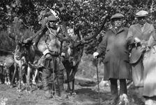 Tourists posing alongside a man with reindeer, Lyngen, Norway, 1929